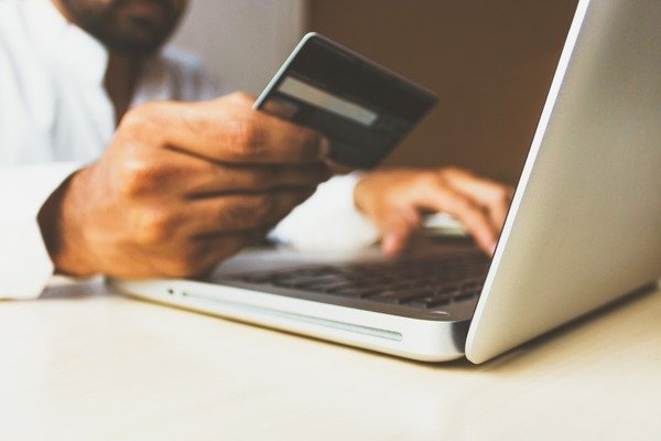 A person placing order, holding debit card for easy checkout