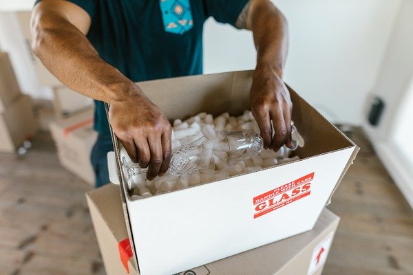 Person packing glass with care